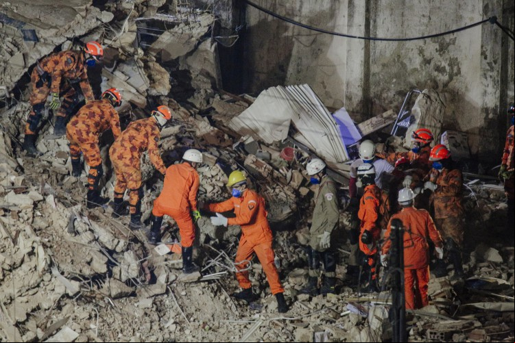 Bombeiros trabalham durante a noite a procura de sobreviventes nos escombros do edifício Andrea
