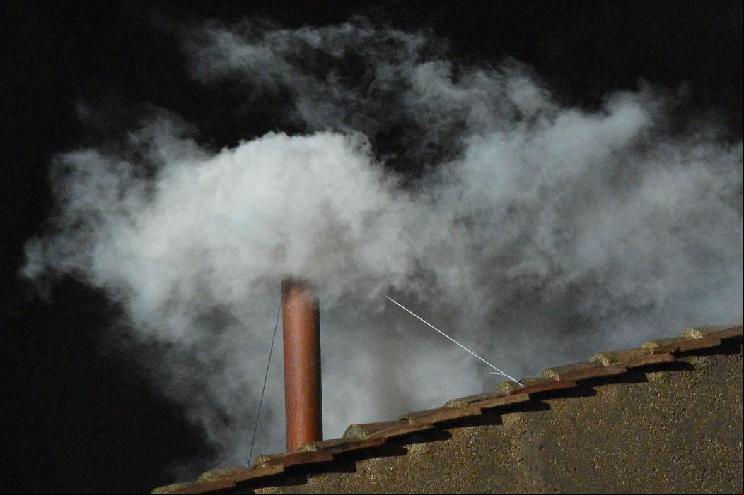 White smoke rises from the chimney on the roof of the Sistine Chapel meaning that cardinals elected a new pope on the second day of their secret conclave on March 13, 2013 at the Vatican. AFP PHOTO / VINCENZO PINTO